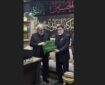 اهدای پرچم حرم امام حسین (ع) برای بدرقه پیکر رهبر شهید